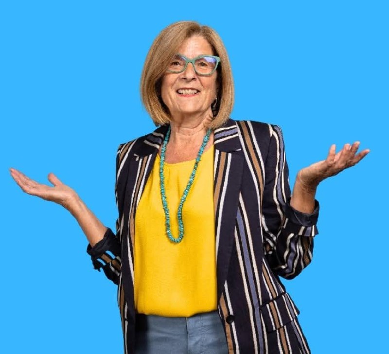Sheela Hagan smiling with her hands open in welcome